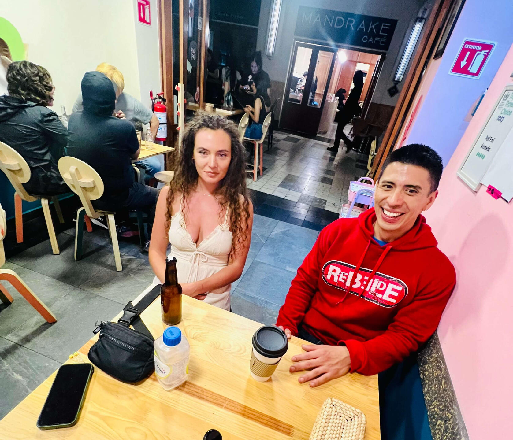 Erik and a guest sharing a relaxed conversation at a local Mexico City café, highlighting the intimate and personal connection built during our curated cultural tours.