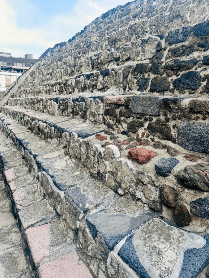 Templo mayor stairs Detail of the ancient stone ruins at the Templo Mayor in Mexico City, highlighting the historical depth of our cultural walking tours.