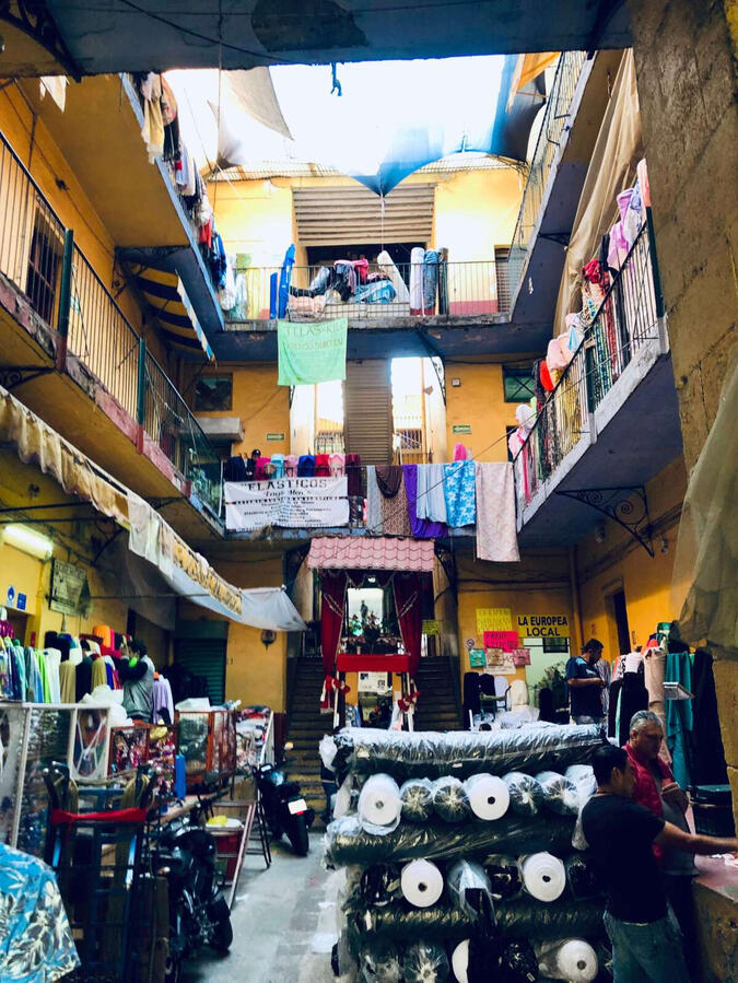 Vecindad Exploring a traditional local fabric market in Mexico City's historic center during a private cultural shopping experience.