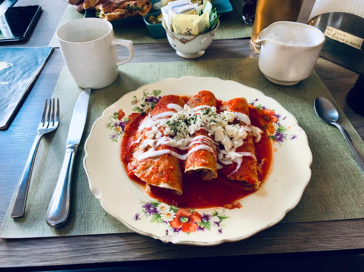 Enchiladas rojas Authentic enchiladas served on a vintage plate, highlighting the local culinary experiences offered in our tour