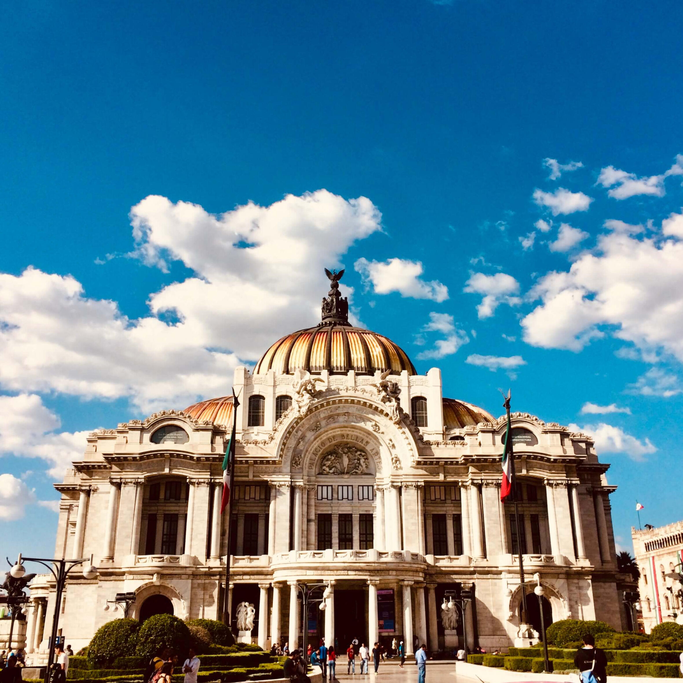 "Bellas Artes" Palace Palacio de Bellas Artes architecture under a bright blue sky during a cultural walking tour in CDMX
