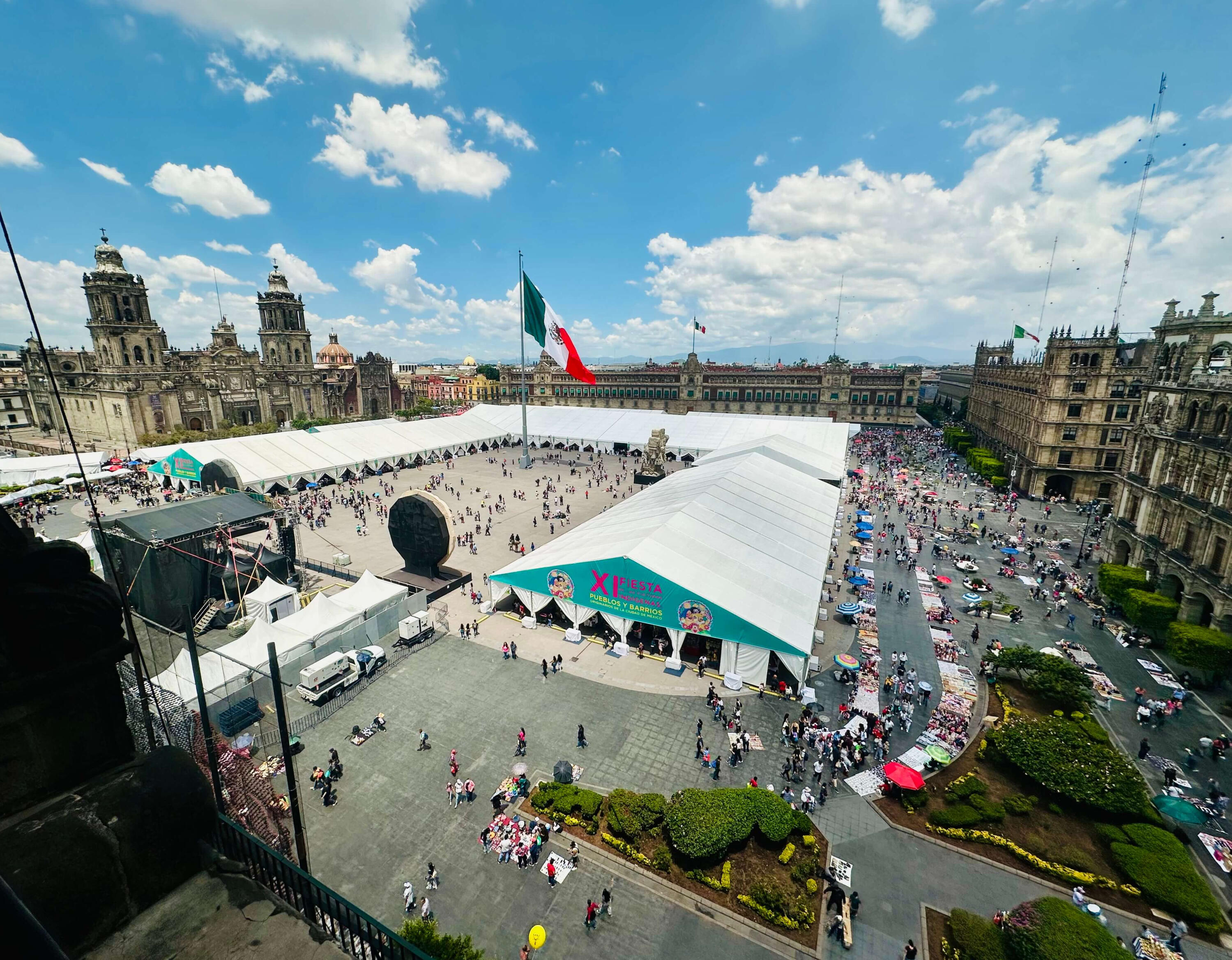 Panoramic aerial view of Mexico City's Zocalo square, featuring the Metropolitan Cathedral and the XI Fiesta de las Culturas, highlighting the vibrant atmosphere of our cultural walking tours.